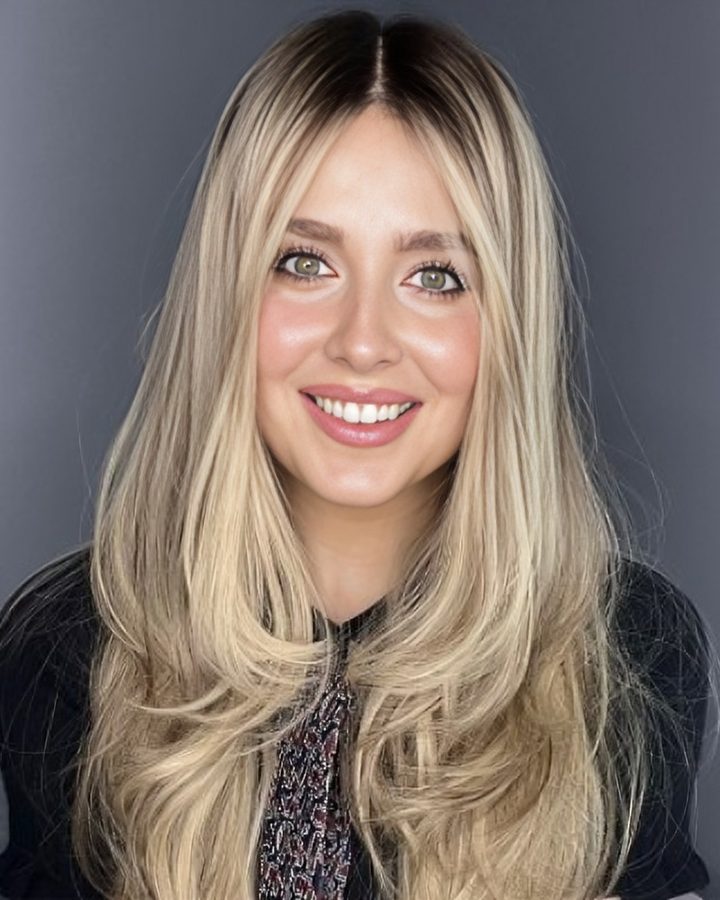 Leah Badach, Certified Exchange Specialist, smiling in a studio portrait